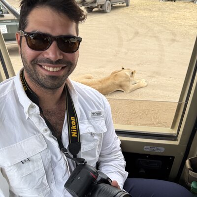 Gregory Glance on safari, lion in the background
